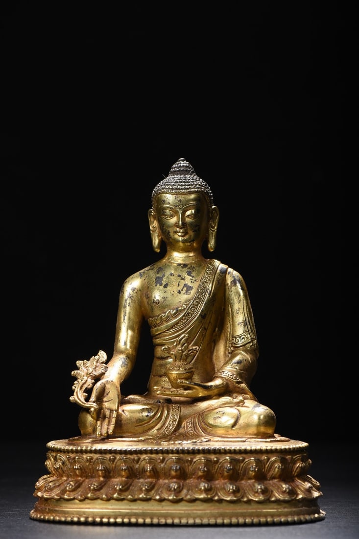 Golden Medicine Buddha Statue: The gold Medicine Buddha statue is 20cm high, 16cm wide, 11cm thick, and weighs 1305 grams. Provenance:from the collection of George Stopher, Kent, purchased from P&M Waldo Antiques, London. Our coope