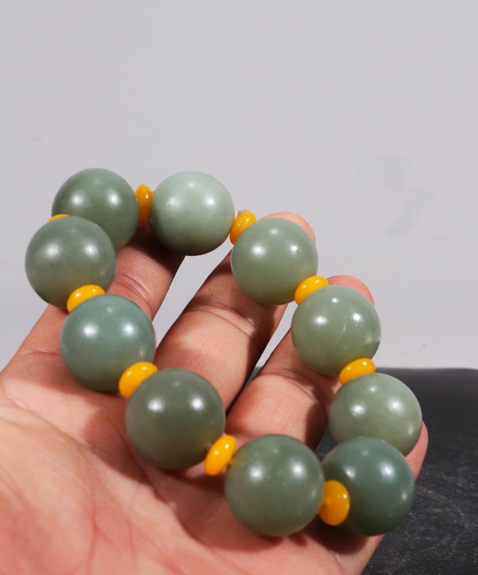 Old Collection of Hetian Jade Pebble Bracelet: This is a collection of Hetian jade seed beads. The jade is delicate and warm to the touch. Each bead has a diameter of 2.0 cm and weighs 61.4 g. Provenance:Private collection from a professor in Univ