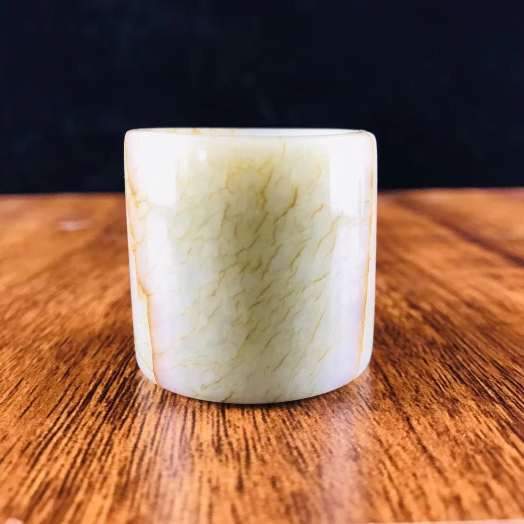 Hetian jade thumb ring: This Hetian jade thumb ring is in excellent condition and well-preserved. The carved image has an inner diameter of 22.2 mm, a width of 35.2 mm, and weighs 55.93 g. Provenance:Private collection from