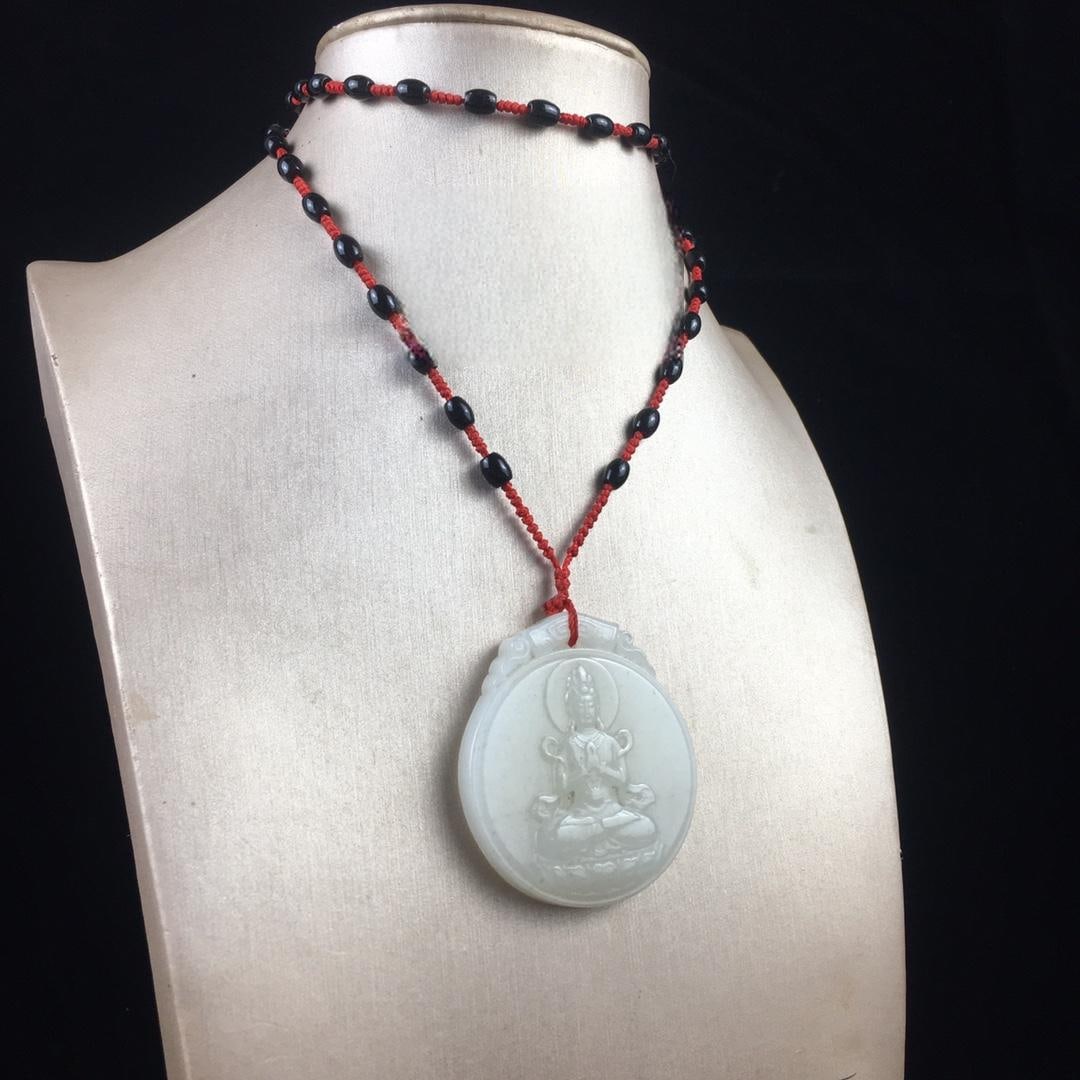 One Hetian jade Guanyin pendant: A Hetian jade Guanyin pendant, exquisitely crafted, with a lustrous and translucent jade quality. Dimensions: 50/44mm, Weight: 41g Provenance:Private collection from a professor in University of Glasg