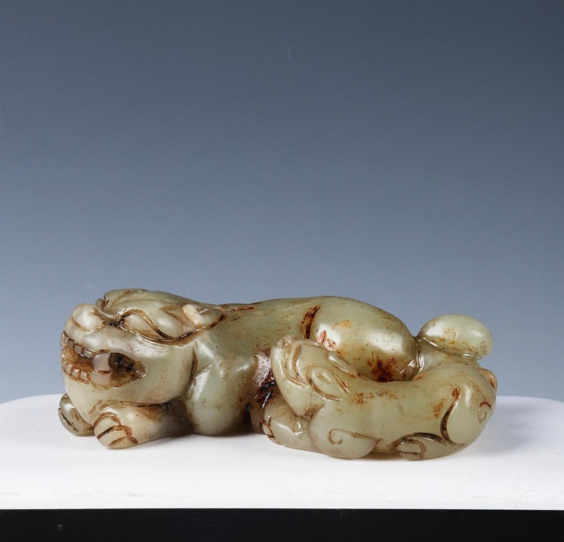 A hand-held piece carved from Hetian jade pebble material from the late Qing Dynasty (1600s) in the: A Qing dynasty late Qing dynasty Hetian jade pebble carving of a mother and child animal. Exquisitely carved, the jade is smooth and lustrous. 8.5cm long, 5cm wide, 2.5cm high, weighing 120g. Provenan