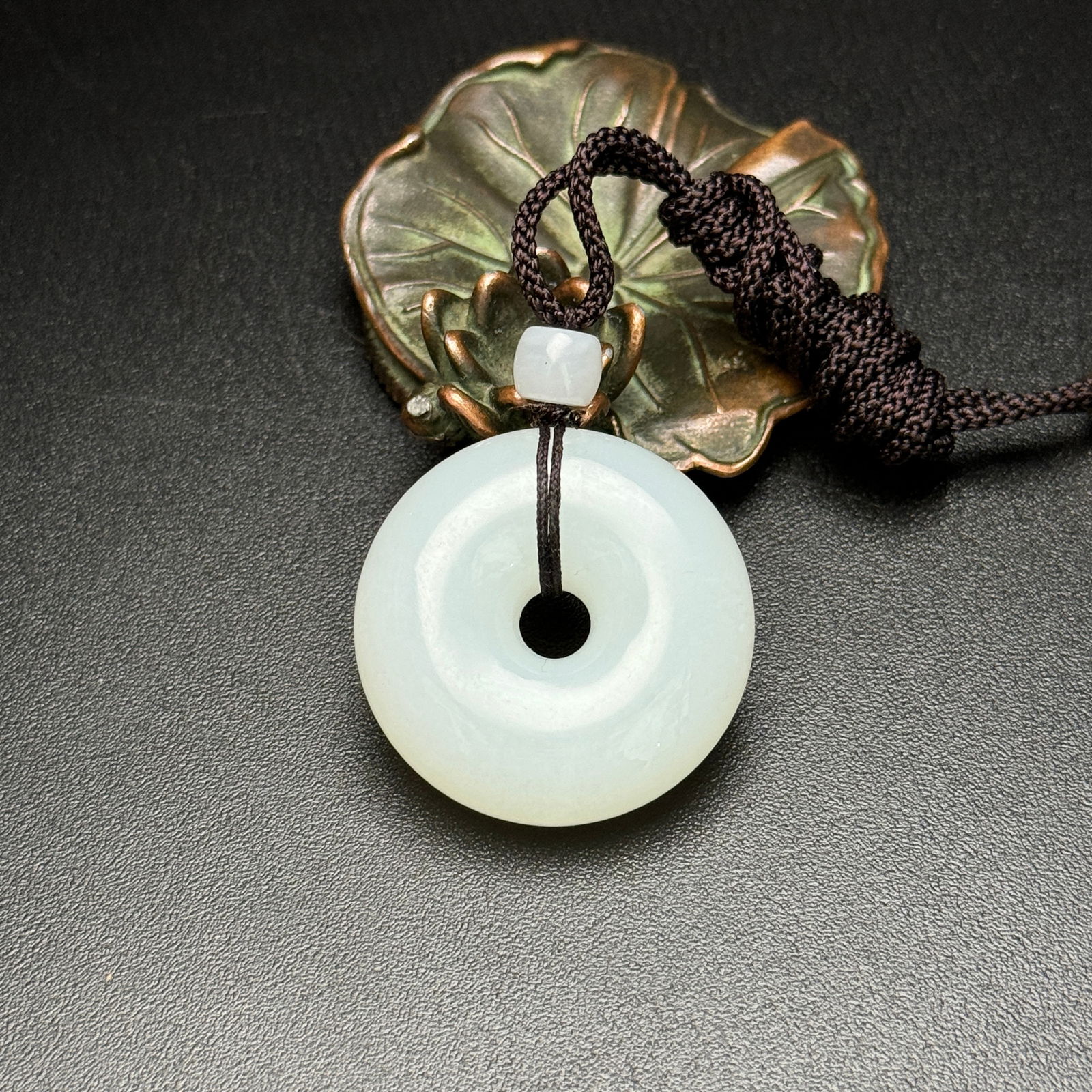 Hetian jade safety buckle: This Hetian jade peace buckle symbolizes peace, good fortune, and a blessed life. The jade is fine, white, and lustrous; a fine piece to wear. Diameter: 32mm, Thickness: 11mm, Weight: 23g Provenance:P