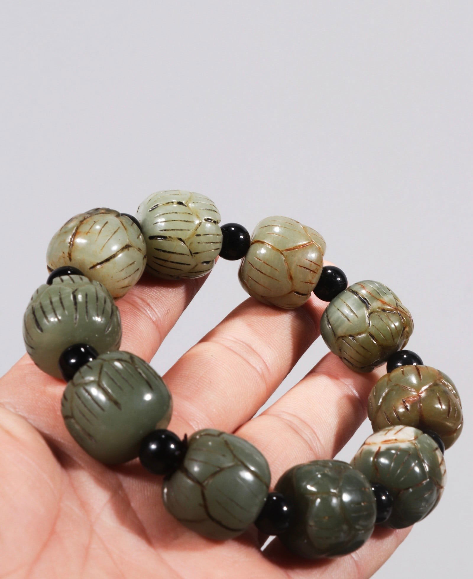 A late Qing dynasty Hetian jade pebble carved with lotus petal pattern bracelet.: A late Qing dynasty Hetian jade pebble bracelet carved with lotus petal design, formerly in the collection. Dimensions: 2.0cm. Weight: 75.4g. Provenance:Private collection from a professor in Newcastl
