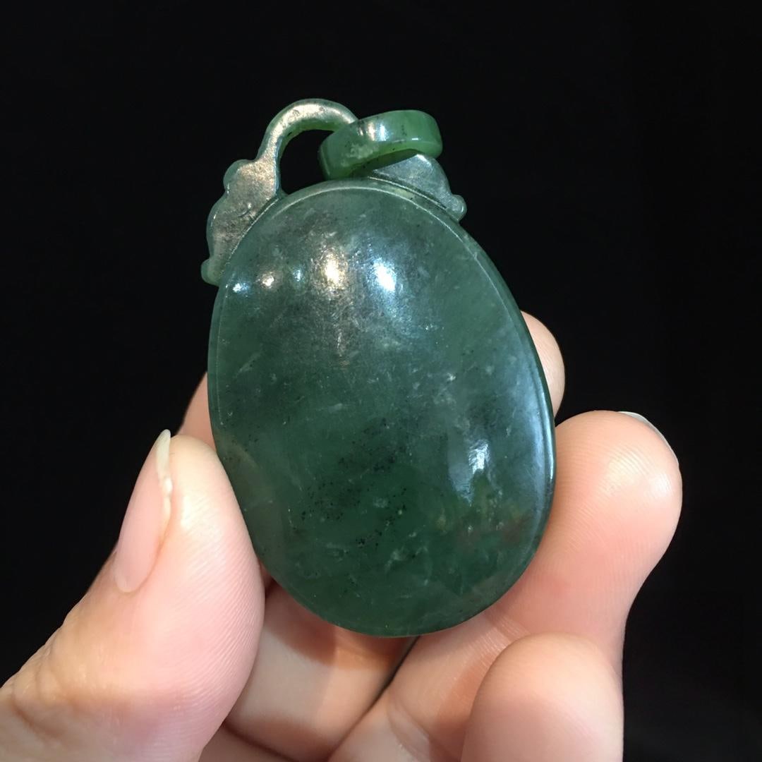 A Hetian jade pendant: A Hetian jade pendant, with a smooth, oily patina, translucent texture, and a smooth feel. Dimensions: 51/31mm, Weight: 30g Provenance:Private collection from a professor in Newcastle University. Our