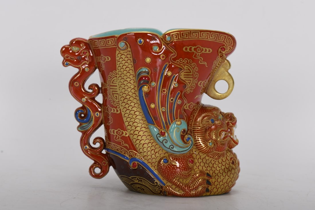 A Qing Dynasty Qianlong period famille rose enamel carved dragon-patterned wine cup with iron-red: Qing Dynasty, Qianlong period, enamel-painted dragon-patterned jade cup with iron-red and gold decoration, 9.7 cm high, 8.8 cm in diameter at the mouth, 10.7 cm in maximum diameter at the base, and 6.
