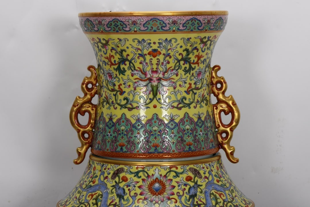 A Qing Dynasty Qianlong period famille rose enamel vase with carved hunting scene of Emperor: Qing Dynasty, Qianlong period, famille rose enamel-painted revolving vase with a hunting scene by Emperor Qianlong, 65 cm high, 19.8 cm in mouth diameter, 32 cm in belly diameter, and 24.3 cm in base