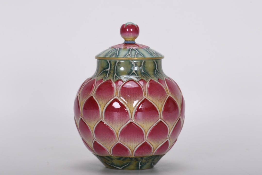 Qing Dynasty, Qianlong Period, Enamel Lotus Covered Jar: A Qing Dynasty, Qianlong period, enamel-painted lotus-shaped covered jar, 13.5 cm high, 6.2 cm in mouth diameter, 10.5 cm in belly diameter, and 4.8 cm in base diameter. Provenance:Private collection