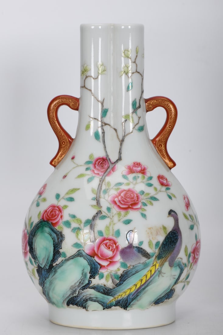 A Qing Dynasty Qianlong period famille rose enamel vase with two handles and two conjoined tubes,: A Qing Dynasty, Qianlong period, famille rose enamel vase with two handles and two conjoined tubes depicting flowers and birds, 23.7 cm high, 5 cm in mouth diameter, 14 cm in belly diameter, and 10 cm