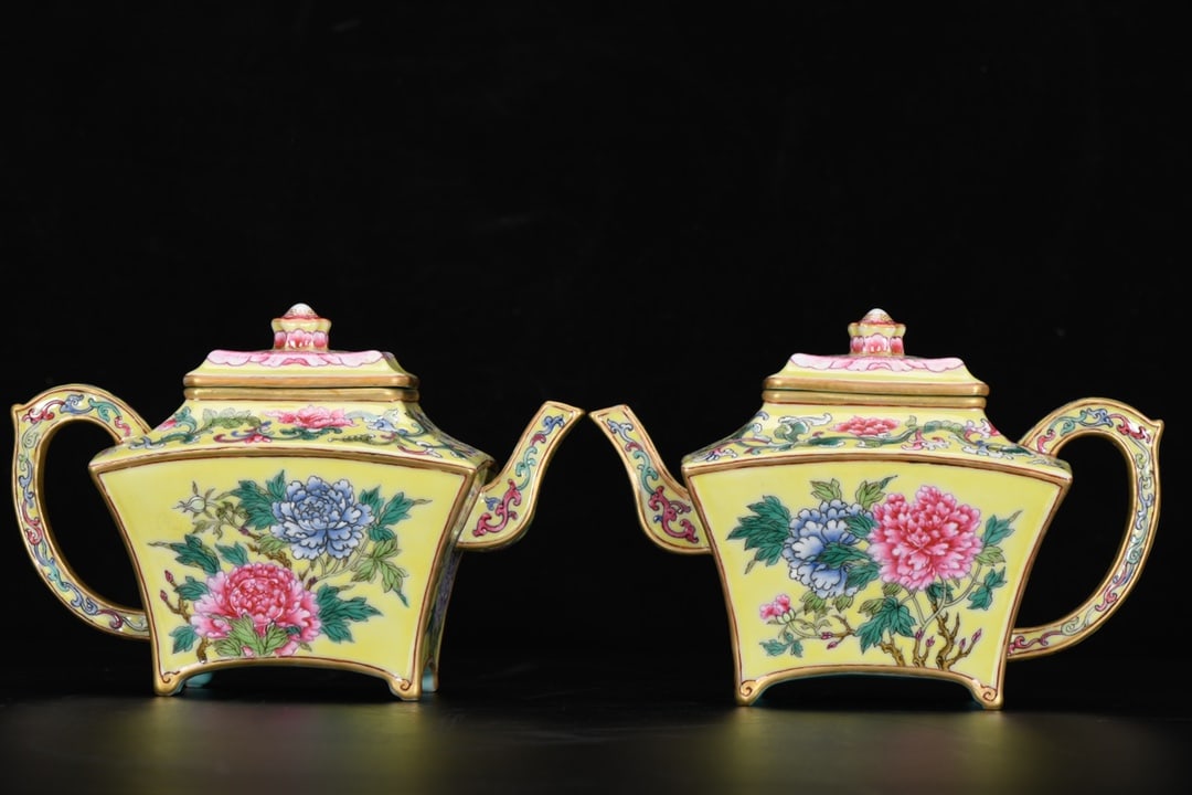 A square fan-shaped enamel teapot with a yellow ground and peony design, dating from the Qianlong: A square fan-shaped enamel teapot with a yellow ground and peony design, dating from the Qianlong period of the Qing dynasty. It is 11 cm high, has a mouth diameter of 6.5 cm, a spout-to-handle distan