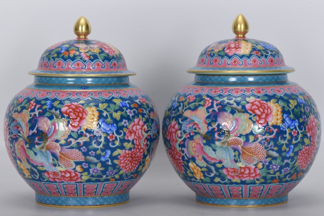 A Qing Dynasty Qianlong period enamel-painted blue-ground butterfly and flower covered jar: A Qing Dynasty, Qianlong period, enamel-painted blue-ground butterfly and flower covered jar, 18 cm high, 9 cm in mouth diameter, 16 cm in belly diameter, and 9 cm in base diameter. Provenance:A notab