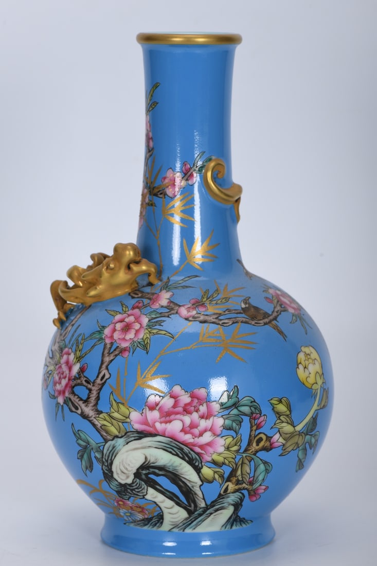 A Qing Dynasty Qianlong period famille rose blue-ground floral and bird-dragon celestial globe vase: A Qing Dynasty, Qianlong period, famille rose enamel blue ground floral and bird dragon celestial globe vase, 23 cm high, 4.5 cm in mouth diameter, 13 cm in belly diameter, and 7.8 cm in base diameter