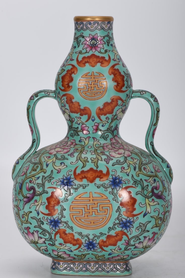 A Qing Dynasty Qianlong period famille rose enamel moon flask with five auspicious symbols and: A Qing Dynasty, Qianlong period, famille rose enamel moon flask with five auspicious symbols on a green ground, 17.5 cm high, 2.5 cm in diameter at the mouth, 10.9 cm in diameter at the belly, and 5.4