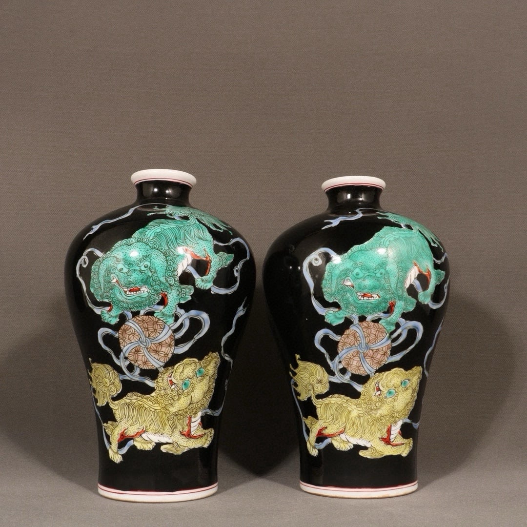 A Qing Dynasty Qianlong Period Ink-Ground Famille Rose Plum Vase with Auspicious Symbols: A Qing Dynasty Qianlong period famille rose enamel vase with a design of auspicious symbols on a black ground, item number 637. Dimensions: Height 23 cm, Diameter 13 cm. Provenance:Private collection