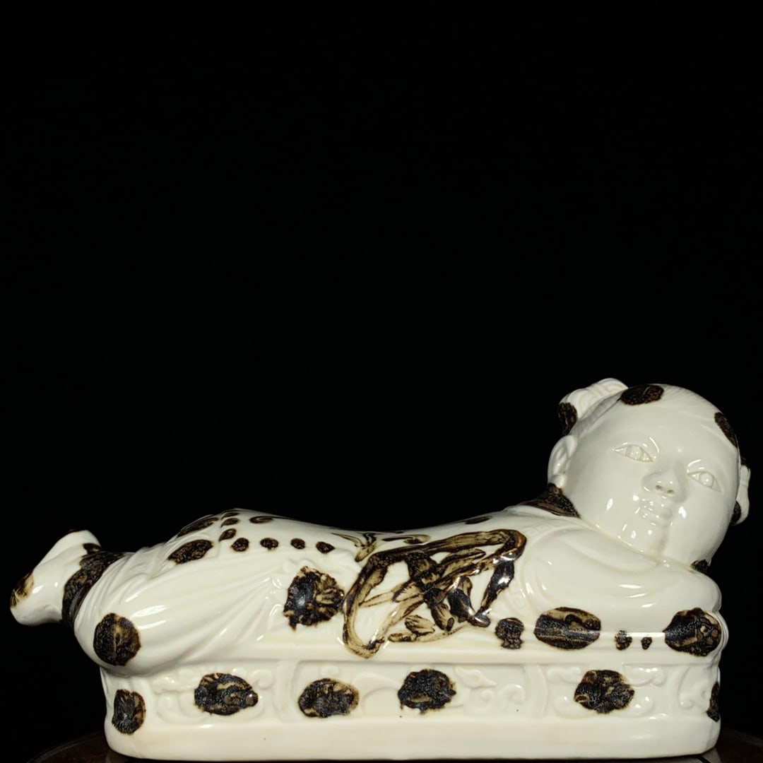 Song Dynasty Ding Kiln Iron-Rust Flower Child Pillow: Song Dynasty Ding ware iron-rust floral child pillow, height 17cm, diameter 36cm Provenance:Private collection from a professor in University of York. Our cooperative logistics services provider exper