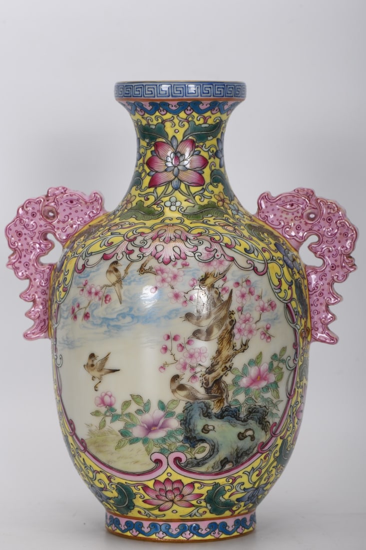A Qing Dynasty Yongzheng period enamel-painted yellow-ground vase with openwork floral and bird: A Qing Dynasty, Yongzheng period, famille rose enamel vase with a yellow ground and openwork floral and bird design, 19.5 cm high, 5.7 cm in diameter at the mouth, 15.3 cm in diameter at the belly, an