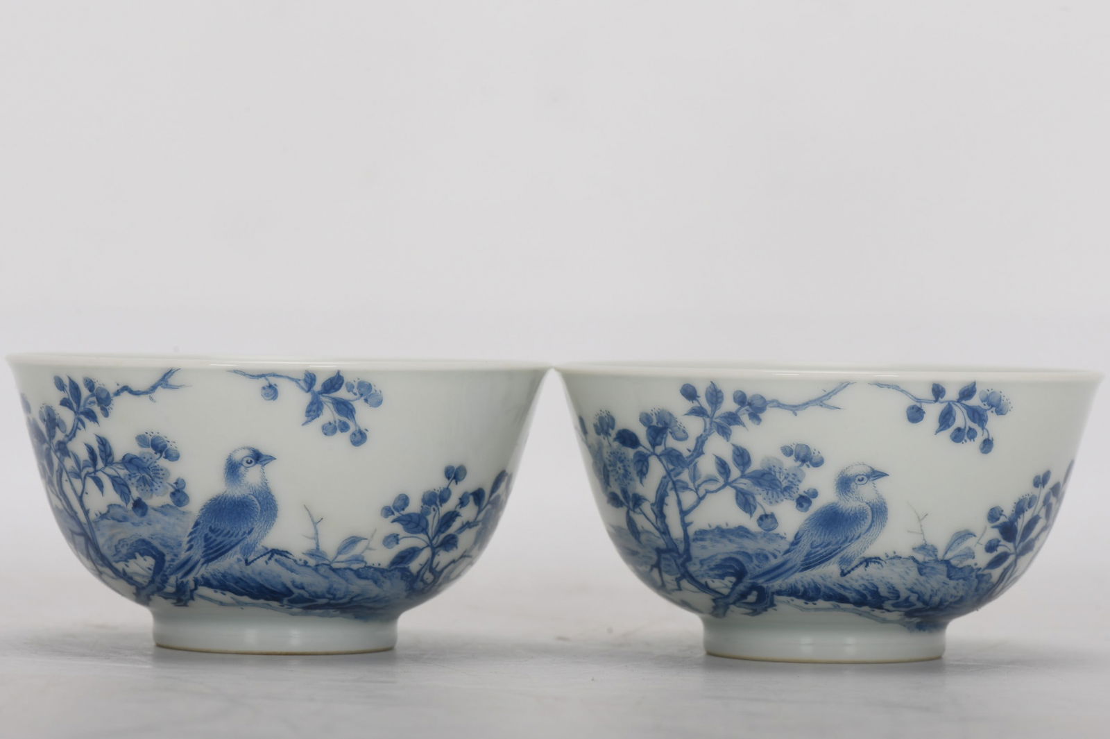 Qing Dynasty, Yongzheng Period, Enamel Blue-Painted Cup with Floral and Bird Designs and Poems: A Qing Dynasty, Yongzheng period, enamel-painted blue cup with floral and bird motifs and poems, 4.7 cm high, 8.8 cm in diameter at the mouth, and 4 cm in diameter at the base. Provenance:from the col