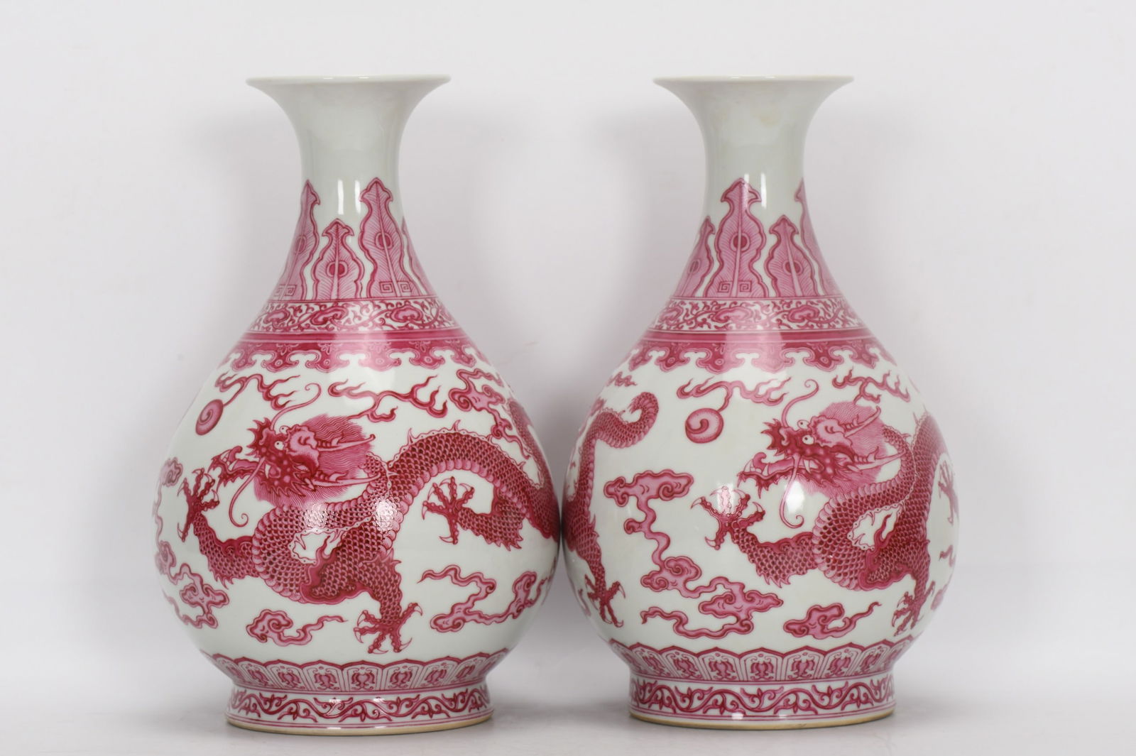 Qing Dynasty, Yongzheng Period, Enamel-painted Rouge Red Double Dragon Playing with Pearl Design: A Qing Dynasty, Yongzheng period, famille rose enamel vase with a design of two dragons playing with a pearl in rouge red, 28.5 cm high, 9 cm in mouth diameter, 18 cm in belly diameter, and 12.2 cm in