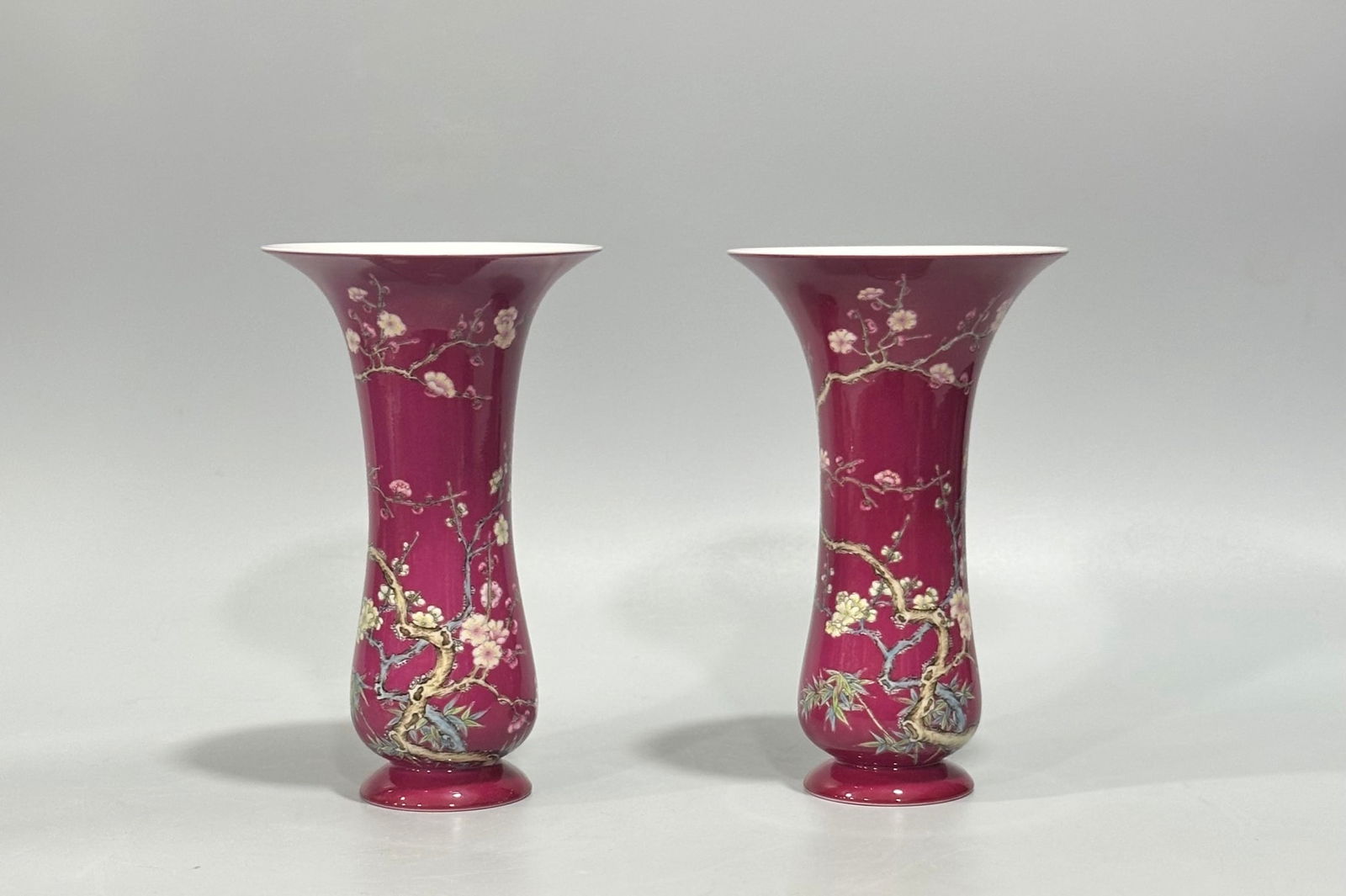 Qing Dynasty, Yongzheng Period: Enamel-painted Rouge-red Plum Blossom and Bamboo Leaf Pattern Flower: Qing Dynasty, Yongzheng Period: Enamel-painted flower vase with rouge-red plum blossom and bamboo leaf design, 15 cm high, 9.3 cm in diameter. Provenance:from the collection of George Stopher, Kent, p