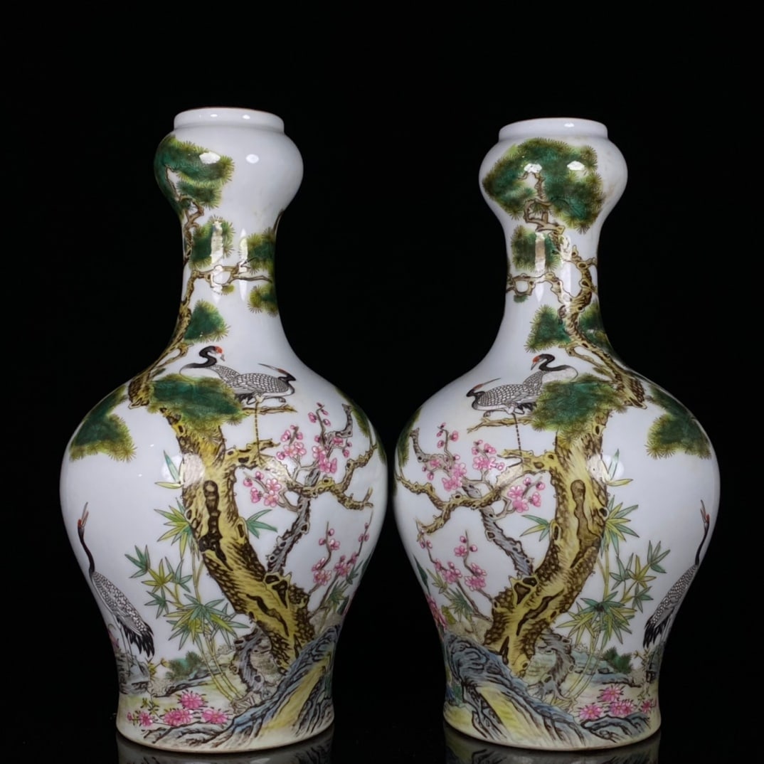 A pair of Qing Dynasty Yongzheng period enamel-painted pine and crane longevity pattern vases: A pair of Qing Dynasty Yongzheng period enamel-painted pine and crane longevity pattern vases, 23 cm high and 12 cm wide. Provenance:from the collection of George Stopher, Kent, purchased from P&M Wal