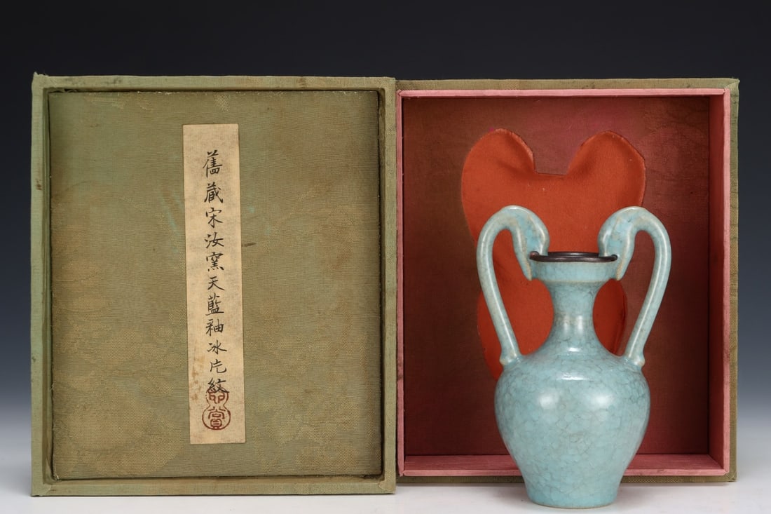 Formerly in the collection of a Song Dynasty Ru ware sky-blue glazed double dragon vase: A Song Dynasty Ru ware sky-blue glazed vase with two dragons, formerly in the collection. Dimensions: Height: 15.5 cm; Diameter: 10.2 cm. Provenance:The Property of a Gentleman in Hampshire, United Ki