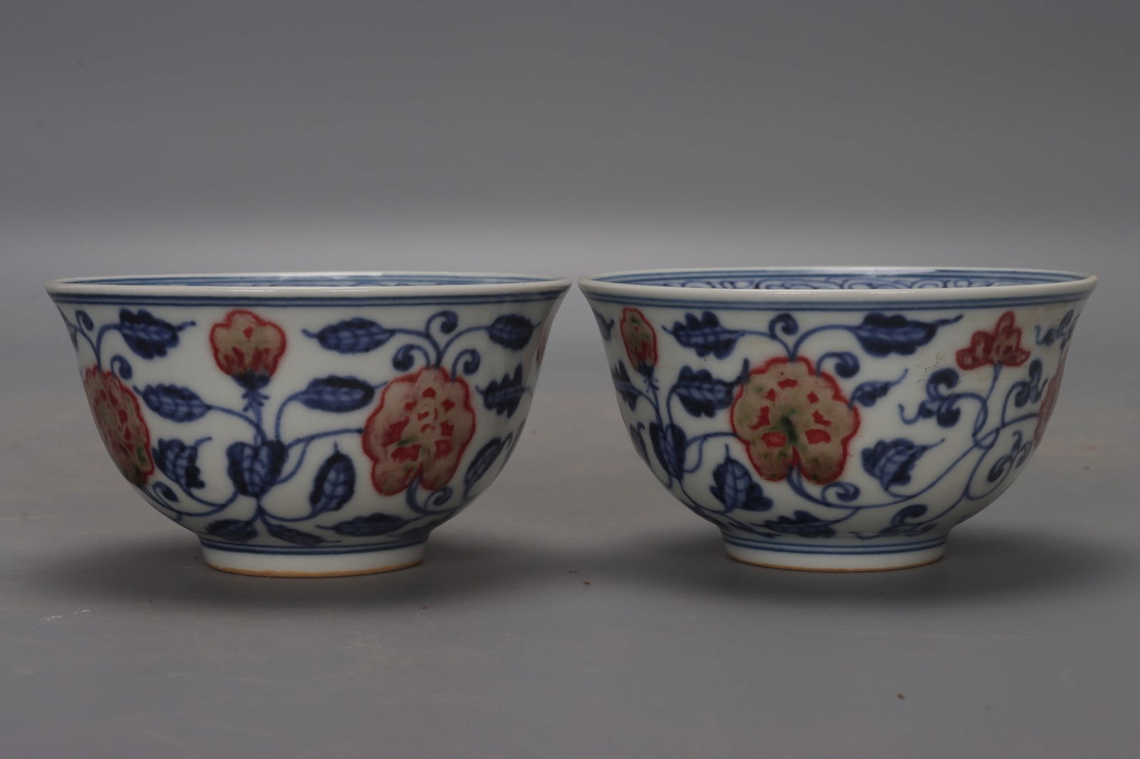A pair of Ming and Xuande blue and white underglaze red lotus scroll cups (1 of 9)