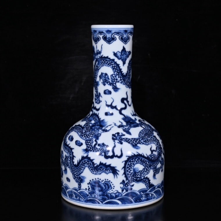 A blue and white porcelain vase with five dragons and a bell, made during the Qianlong reign of the: A blue and white porcelain vase with five dragons and a bell, made during the Qianlong period of the Qing Dynasty, measuring 18x11cm. Provenance:Private collection from a professor in University of Ox