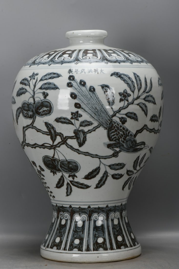 A Ming Dynasty, Hongwu period blue and white porcelain plum vase with floral, bird, and pomegranate: A Ming Dynasty, Hongwu period blue and white porcelain plum vase with floral, bird, and pomegranate design. It is 40 cm high, 8.5 cm in diameter at the mouth, 29 cm in diameter at the belly, and 19.5