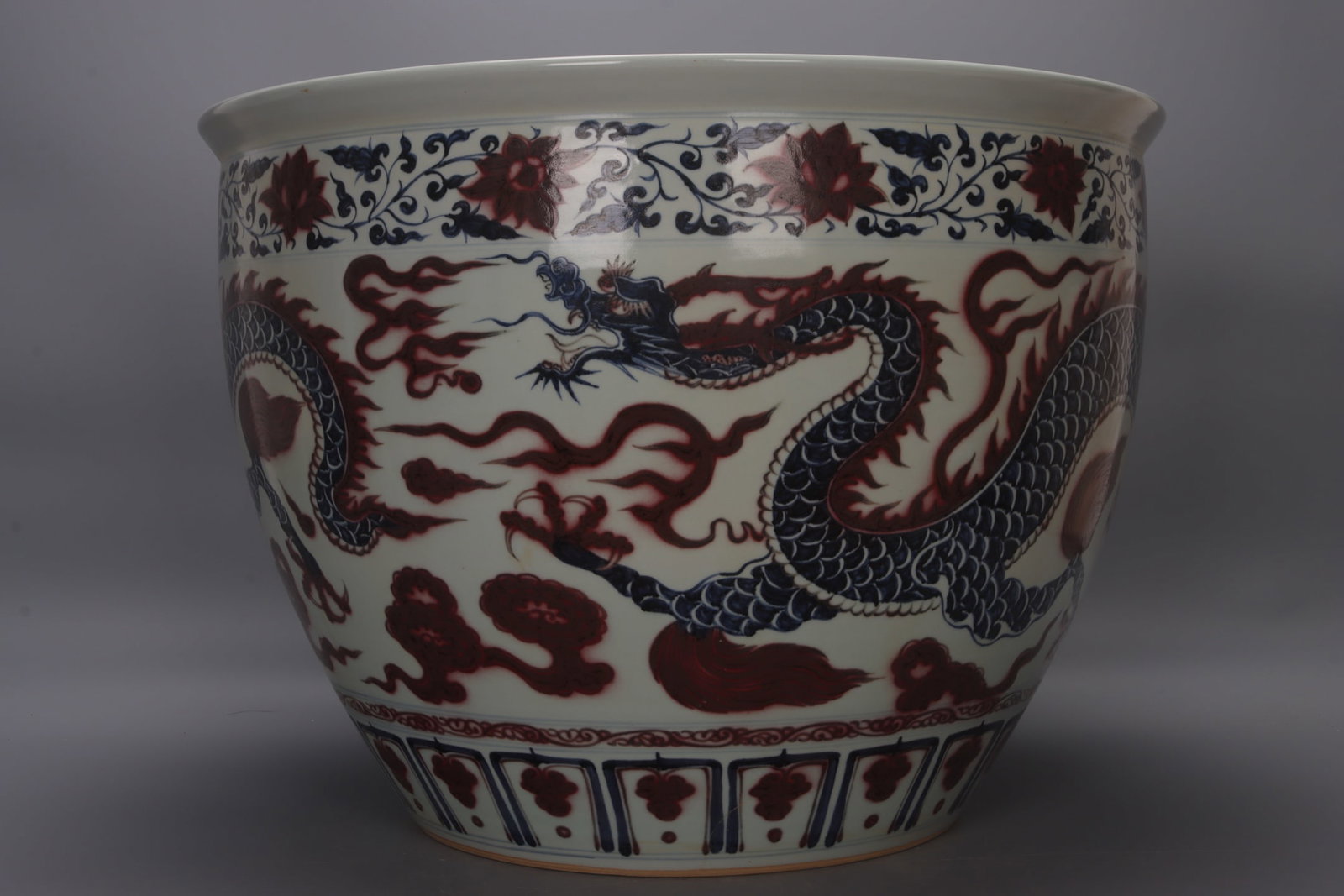 A large Ming dynasty blue and white underglaze red jar with double dragons, cloud patterns, and (1 of 9)