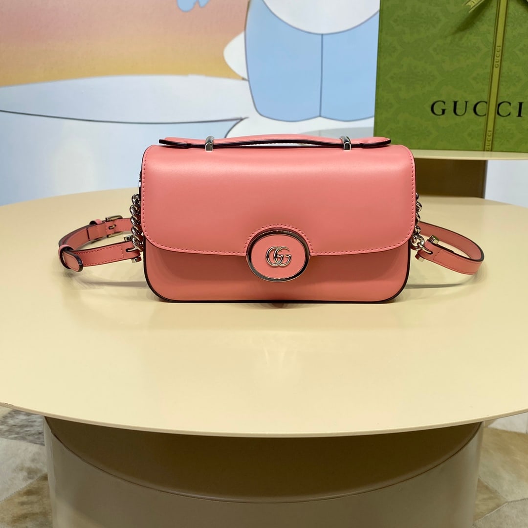 Petite GUCCI: The pink Petite GUCCI mini shoulder bag features a soft yet structured silhouette with a top zip closure and cleverly incorporates the double G logo. This piece has an adjustable leather shoulder
