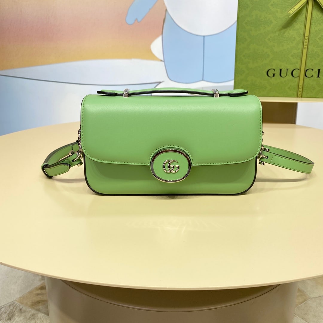 Petite GUCCI: The Petite GUCCI Mini Shoulder Bag in green features a soft yet structured silhouette with a top zip closure and cleverly incorporates the double G logo. This piece has an adjustable leather shoulder 