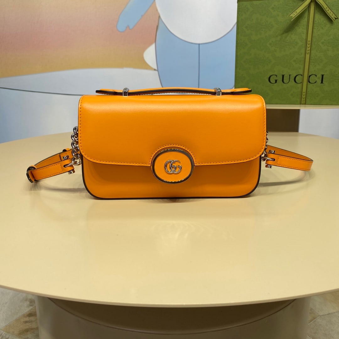 Petite GUCCI: The Petite GUCCI Mini Shoulder Bag in orange features a soft yet structured silhouette with a top zip closure and cleverly incorporates the double G logo. This piece has an adjustable leather
