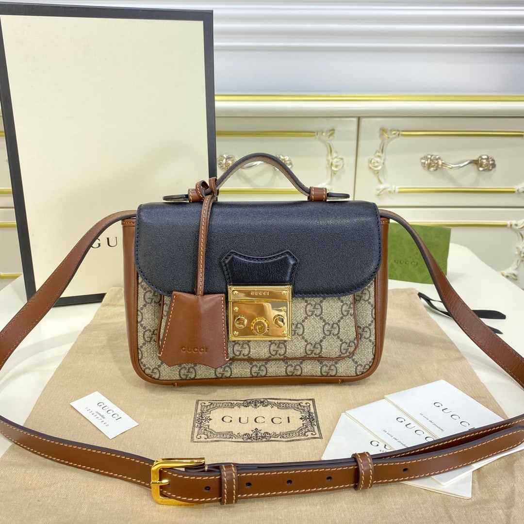 GUCCI Padlock: The GUCCI Padlock mini handbag from the Black Prelude series interprets the brand's iconic style in a miniature form. This Padlock piece is a fresh take on the petite design, crafted from GUCCI Suprem