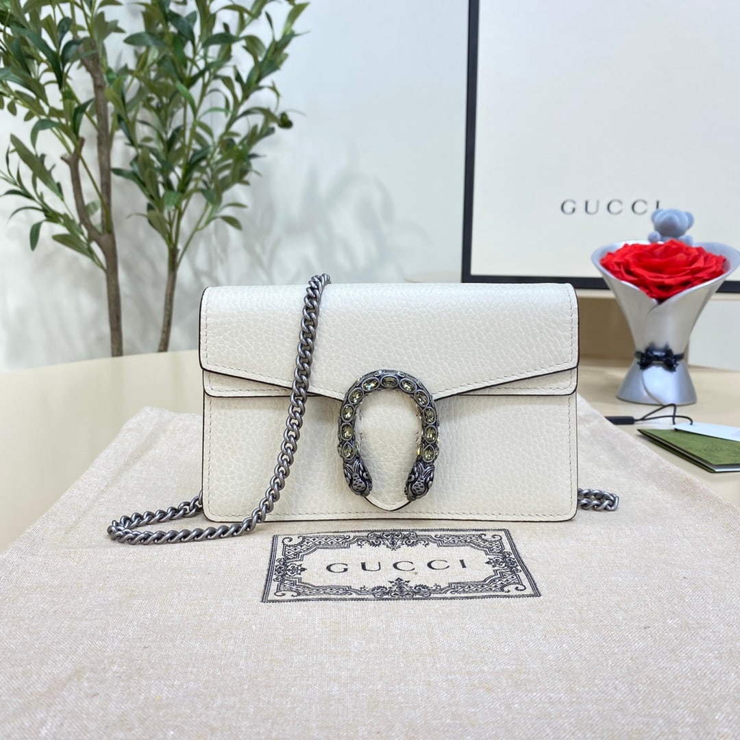 GUCCI Dionysus: The GUCCI Dionysus series leather mini handbag is a white, structured leather chain mini handbag crafted from sturdy textured leather. It comes with a key ring for attaching to a larger handbag. The
