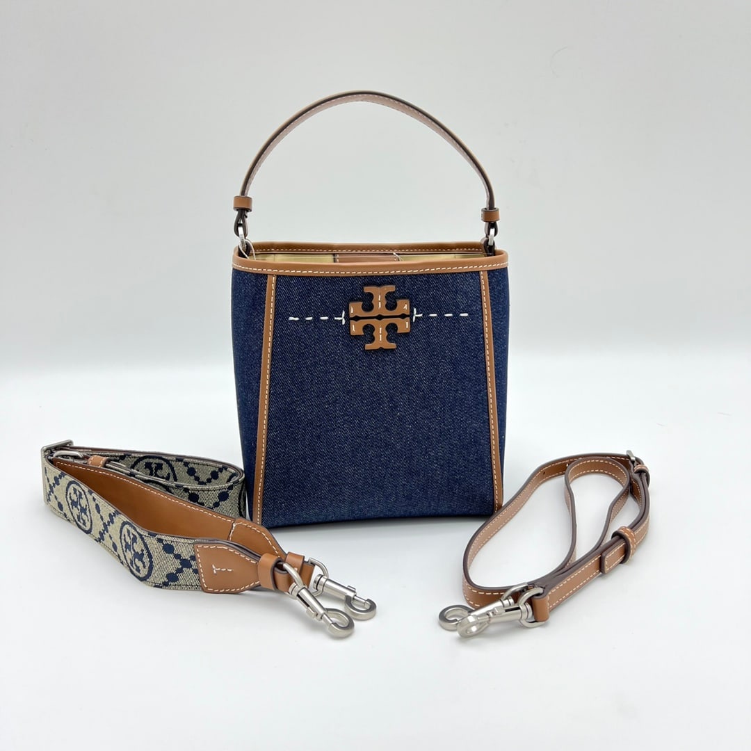 Tory Burch Women's Handbag/Shoulder Bag/Crossbody Bag: The Tory Burch women's handbag/shoulder bag has a different shape when the buckle is fastened. It's made of denim and leather, and features a wide monogrammed shoulder strap. Dimensions: 19 x 12.5 x