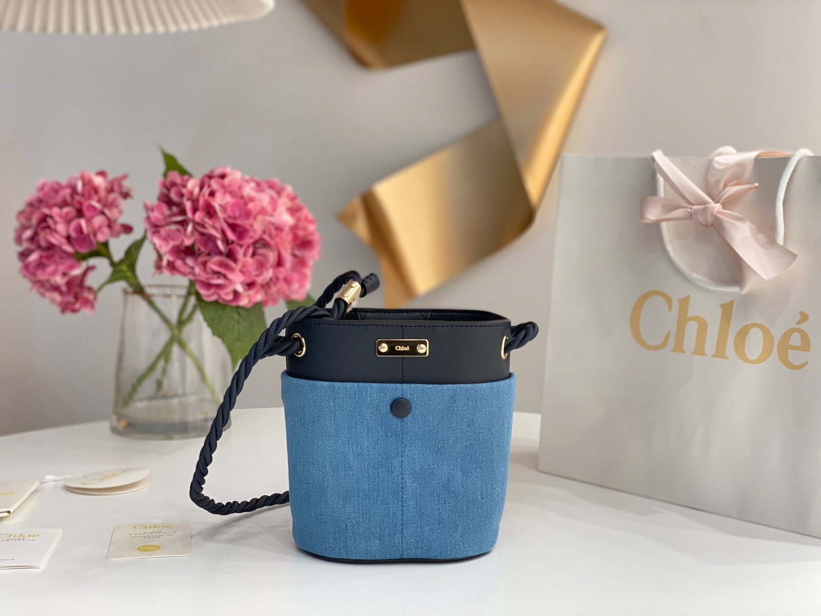 Chloe: The Chloe Key bucket bag in denim is a spring/summer essential. This KEY bucket bag features a cleverly designed rope shoulder strap and multiple compartments, each with its own function, making it
