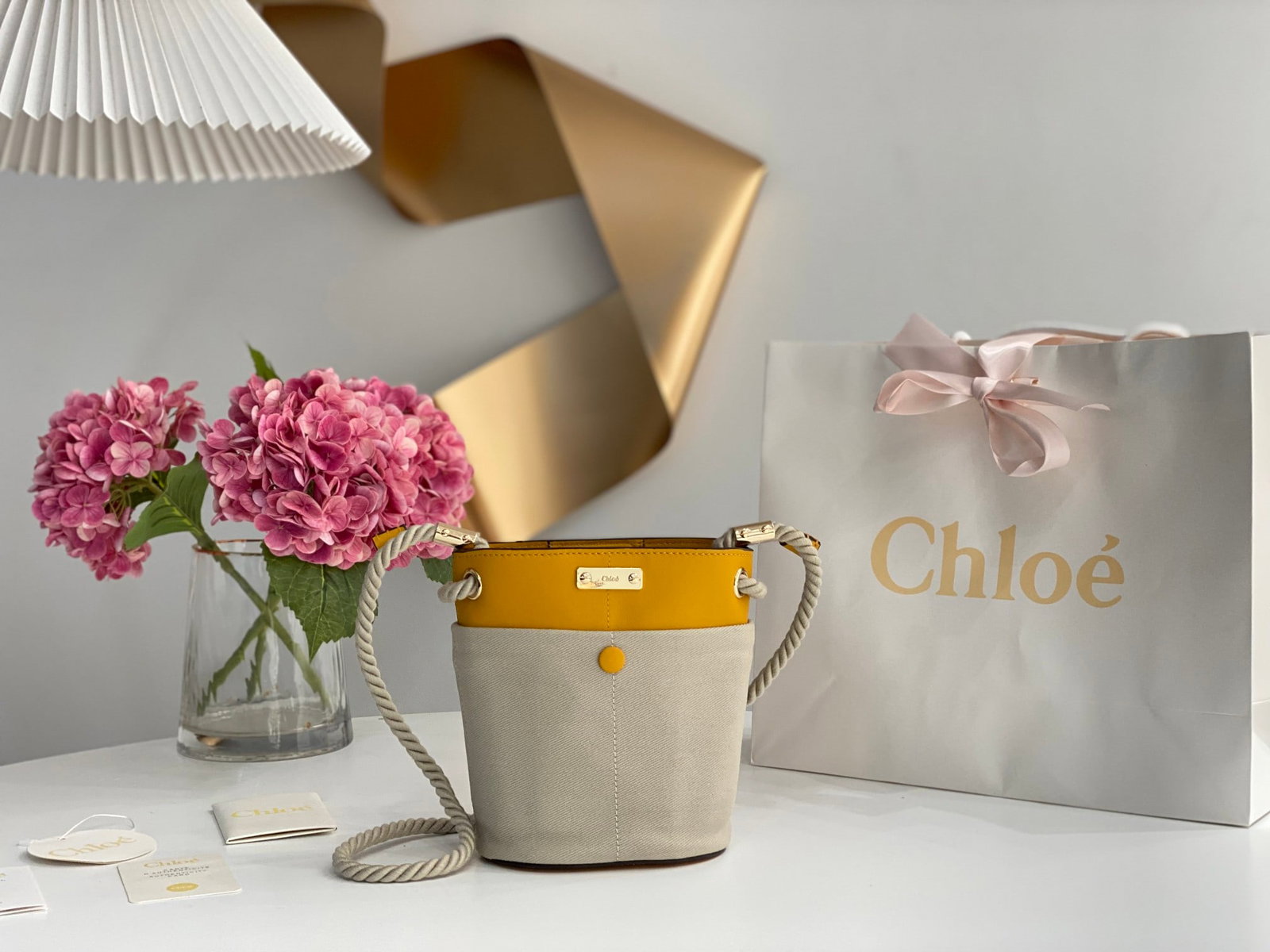 Chloe: The Chloe Key bucket bag in yellow with fabric accents is a spring/summer essential. This KEY bucket bag features a cleverly designed rope shoulder strap and multiple compartments, each with its own