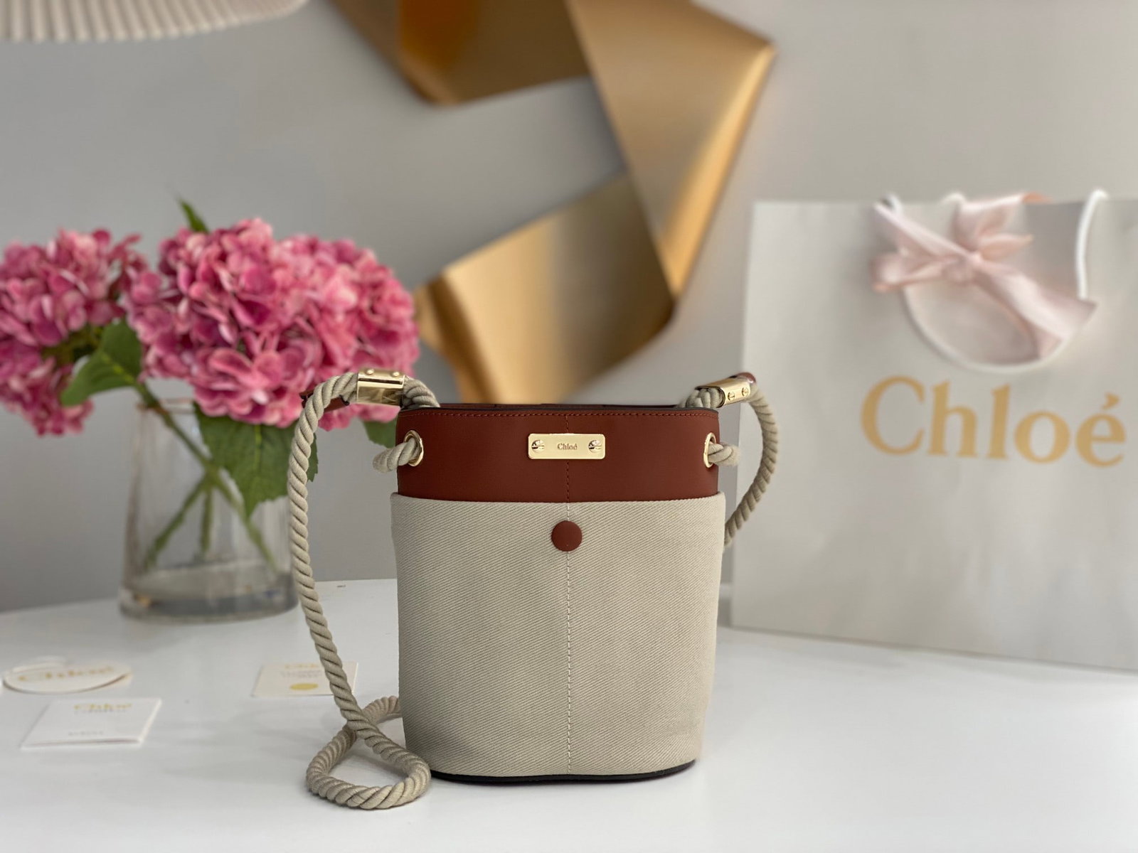 Chloe: The Chloe Key bucket bag in brown with fabric accents is a spring/summer essential. This KEY bucket bag features a cleverly designed rope shoulder strap and multiple compartments, each with its own