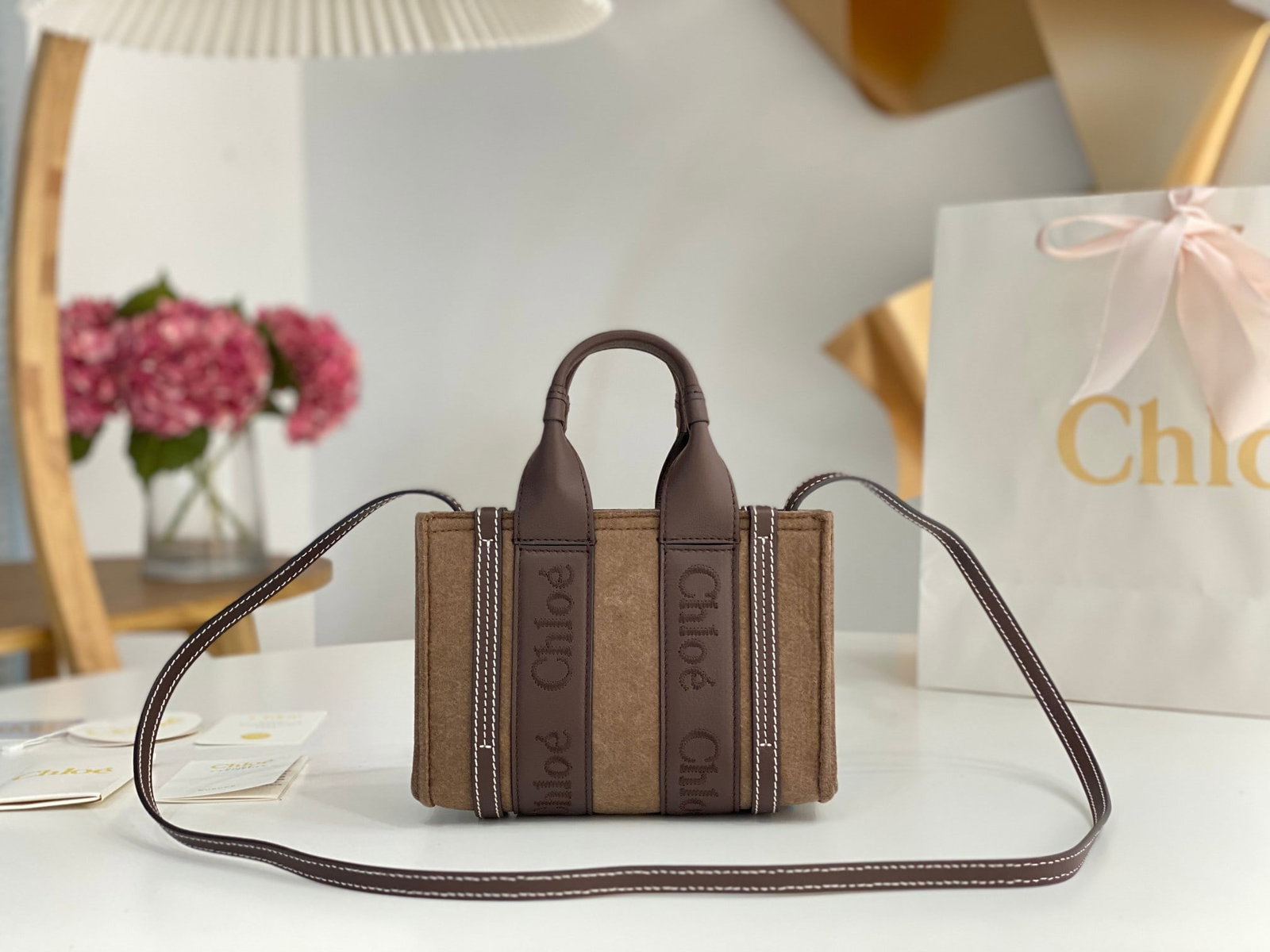 Chloe: Mini Chloe felt and leather trim. The felt material instantly evokes a wintery feel, looking so warm and cozy. The Chloe embroidered logo and leather ribbon add even more texture, making it absolutely