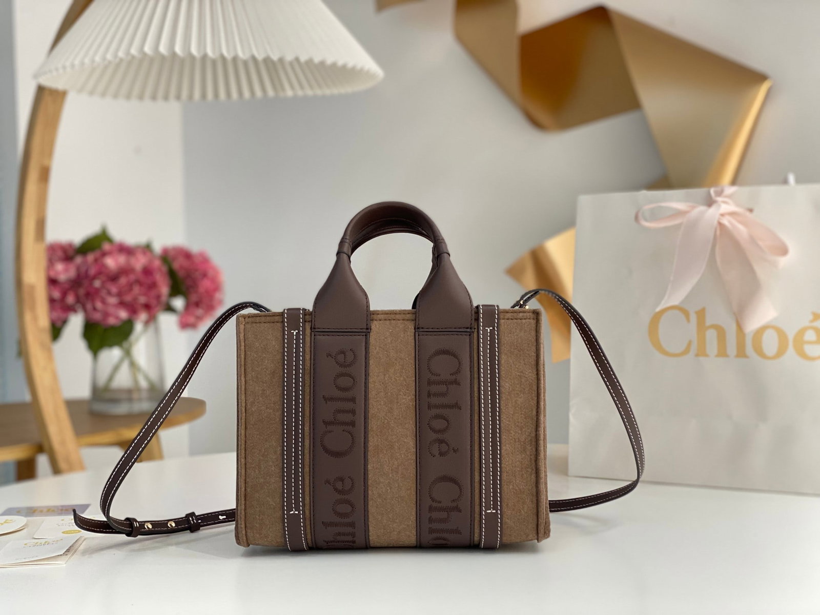 Chloe: Chloe felted woody with leather trim. The felted material instantly evokes a wintery feeling; it looks so warm and cozy. The Chloe embroidered logo leather ribbon adds even more texture, and it's