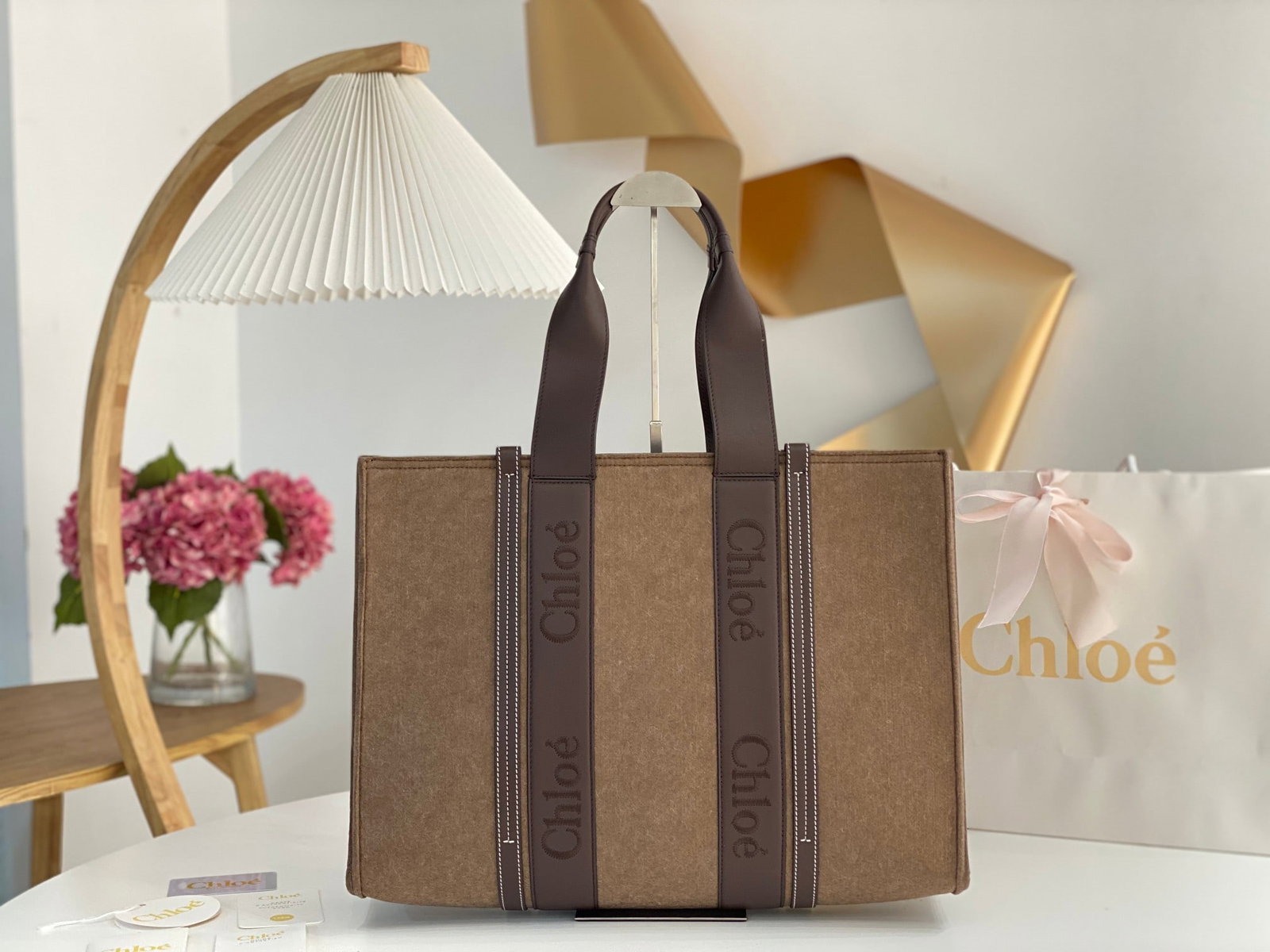 Chloe: Chloe felted woody with leather trim. The felted material instantly evokes a wintery feeling; it looks so warm and cozy. The Chloe embroidered logo leather ribbon adds even more texture, and it's abso