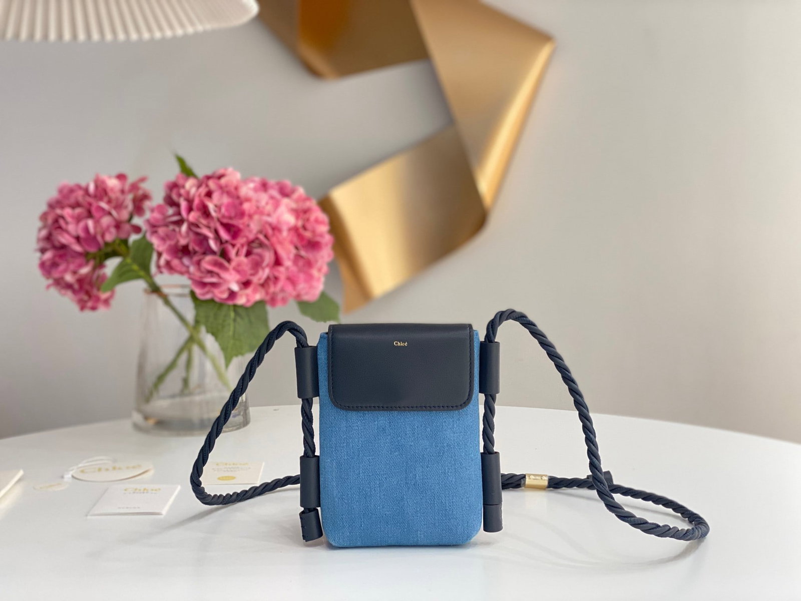 Chloe: Denim Chloe S2022 Summer Key X Phone Bag, featuring an adjustable shoulder strap, a main compartment for all phone models, and two external card slots. It's truly beautiful, simple, lightweight, and p