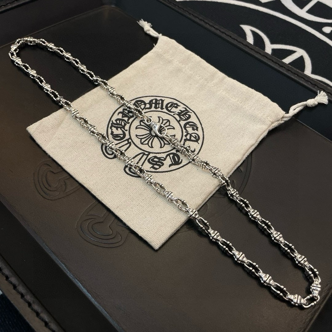 Chrome Hearts necklace: The Chrome Hearts necklace features unique embossed designs with varying patterns, creating a distinctive look. The cross and scout flower are the hallmarks of Chrome Hearts, ensuring its enduring app