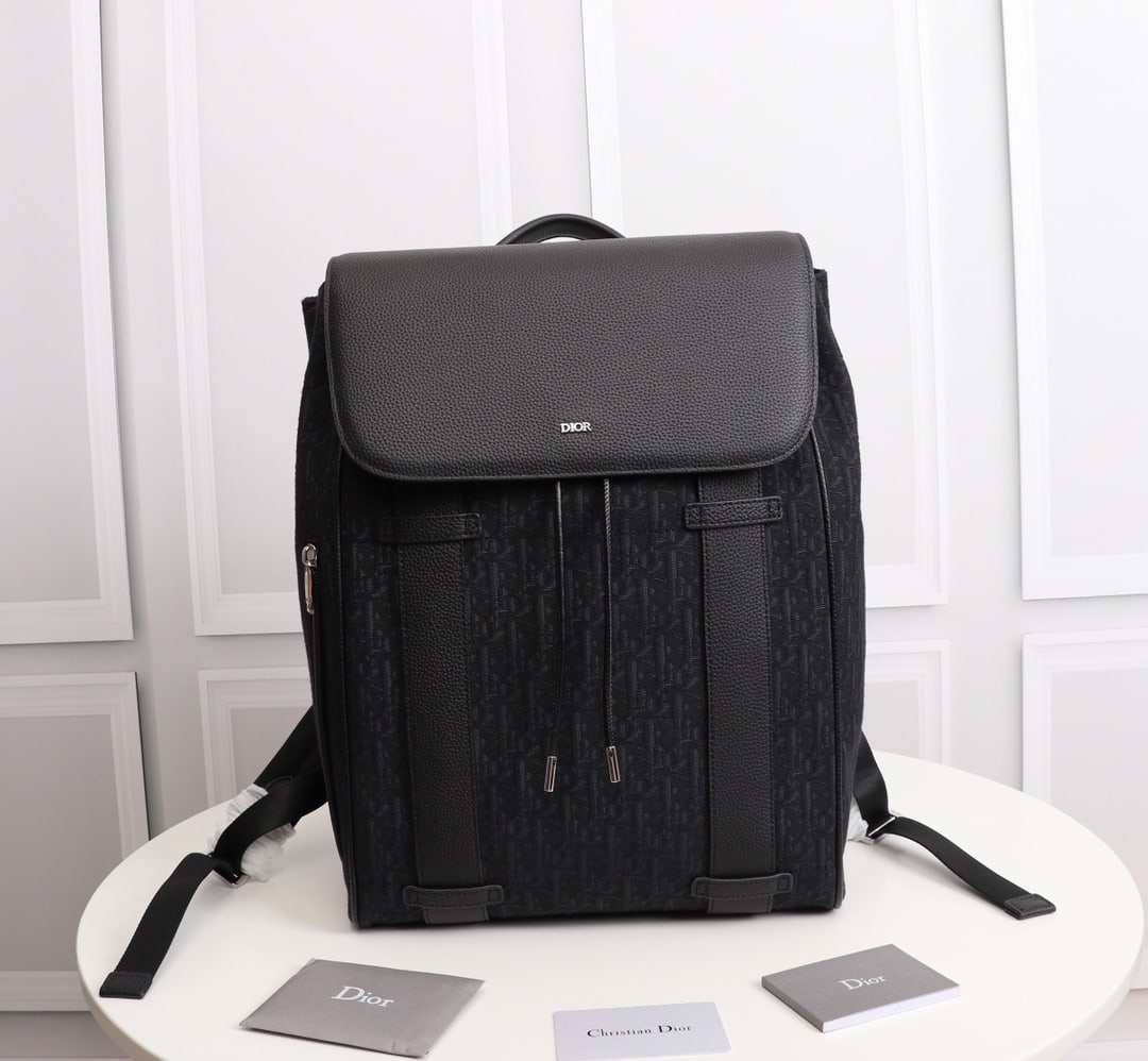 Christian Dior: Dior Oblique Men's Backpack (Black Jacquard) Motion Black Dior Oblique Black jacquard and smooth black calfskin leather backpack, exterior Dior finish, interior Dior logo heat-stamped, 1 interior flat