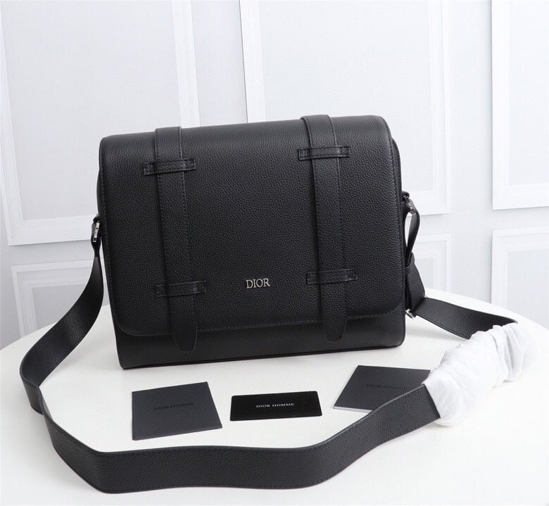 Christian Dior: Black full leather, black Oblique print, black calfskin leather, front DIOR logo with embossed DIOR logo inside, adjustable leather shoulder strap, flap with zip closure, interior slip pocket. Can be 
