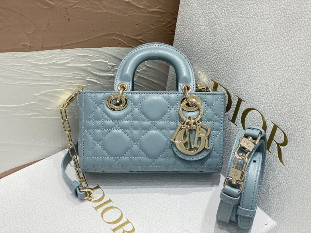 Christian Dior: The ultra-mini Dior d-joy Lady D-Joy handbag in sky blue embodies Dior's profound understanding of elegance and beauty. This sophisticated and classic design is crafted from blue cannage-stitched lamb