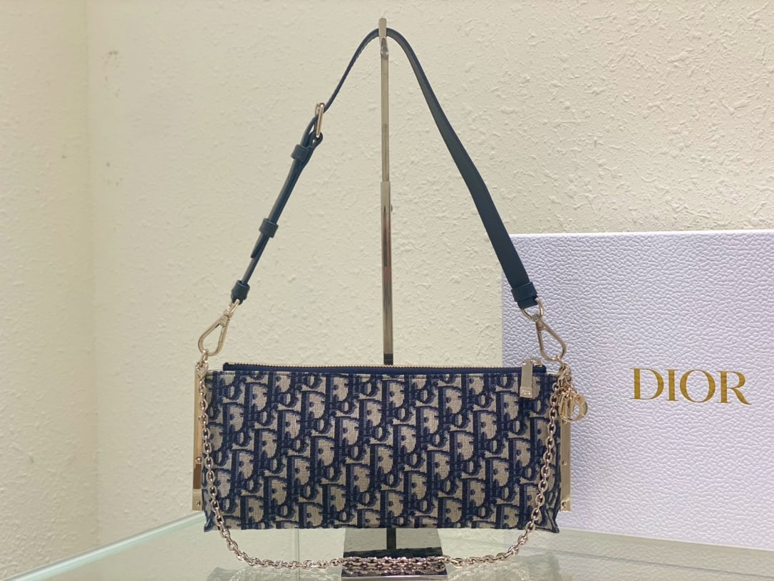 Christian Dior: The DIOR CLUB handbag in blue Oblique print is a standout piece, highlighting a striking and practical design adorned with Dior's classic logo. It adds a modern touch and elegance to the summer of
