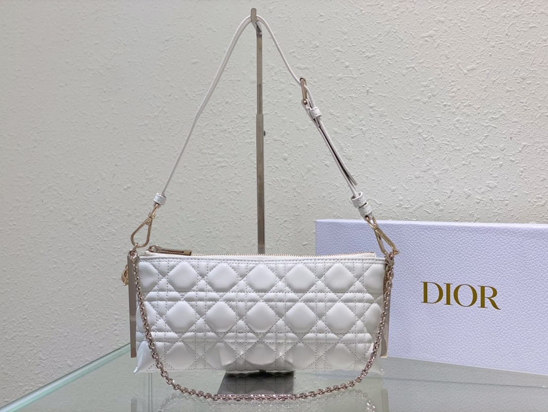 Christian Dior: The DIOR CLUB handbag in white lambskin cannage is a standout piece, highlighting a striking and practical design adorned with Dior's classic logo. It adds a modern touch and elegance to the summer