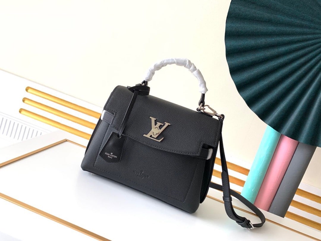 LV: Made from grained calfskin, this piece combines elegant design with practicality. Delicate details such as the LV clasp and key pouch accentuate its simple lines, while the structured form provides am
