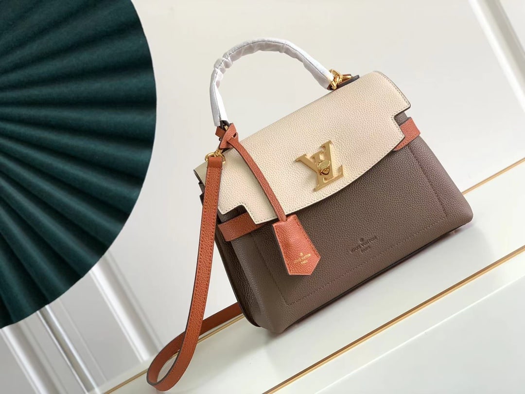 LV: Made from grained calfskin, this piece combines elegant design with practicality. Delicate details such as the LV clasp and key pouch accentuate its simple lines, while the structured form provides am