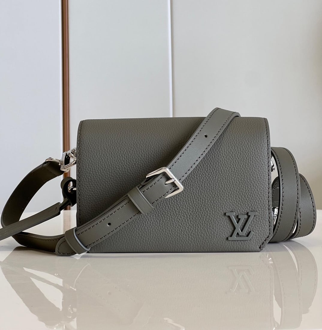 LV Fastline: The military green Fastline mini handbag combines grained calfskin with a distinctive Aerogram design, featuring a bias-cut flap detail and LV lettering on the front corner. A detachable shoulder